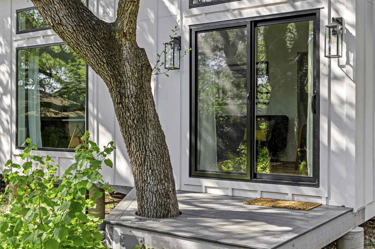 RedOven Builds custom home backyard design with patio seating and trees Austin TX 3102 S Oak Dr