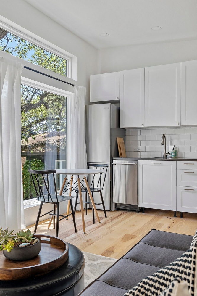 ADU living and kitchen space by RedOven Builds in 3102 S Oak Dr TX with large windows and modern furnishings