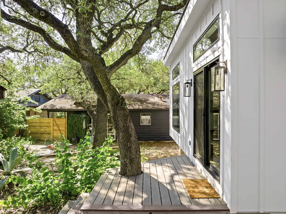 RedOven Builds custom home deck with tree integration and backyard view Austin TX 3102 S Oak Dr