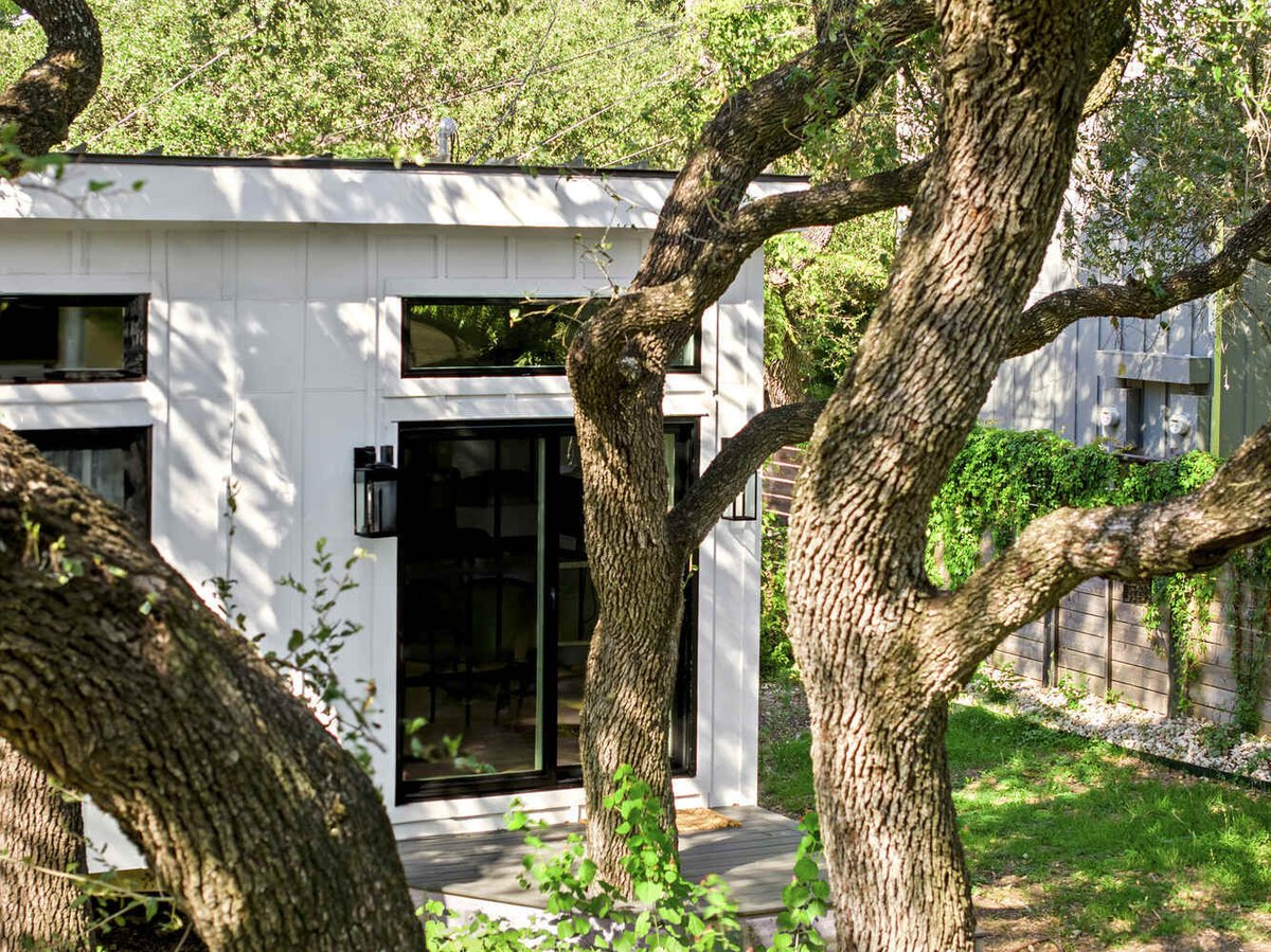 RedOven Builds custom home exterior framed by mature trees Austin TX 3102 S Oak Dr