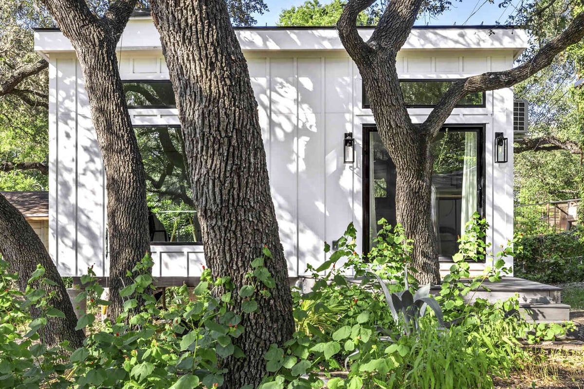 RedOven Builds custom home exterior surrounded by large oak trees Austin TX 3102 S Oak Dr