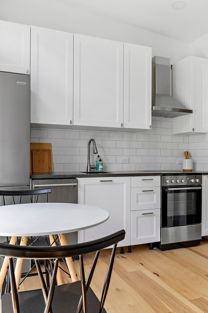 RedOven Builds custom home kitchen with white cabinetry and stainless steel appliances Austin TX 3102 S Oak Dr