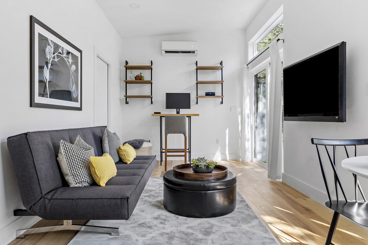 RedOven Builds custom home living room with sofa and workspace Austin TX 3102 S Oak Dr