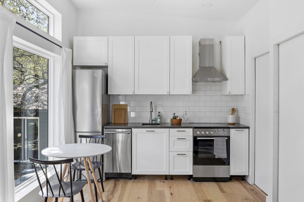 RedOven Builds custom home open concept kitchen with seating area Austin TX 3102 S Oak Dr