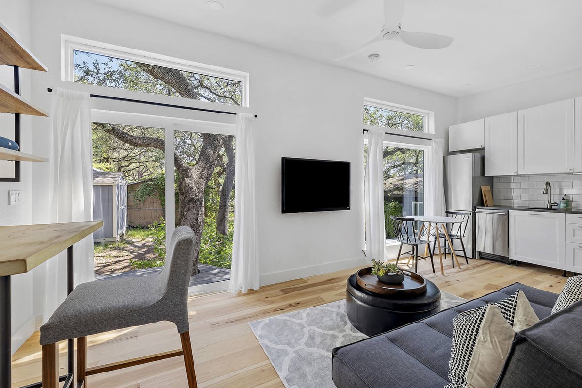 RedOven Builds custom home open concept living room and kitchen with large windows Austin TX 3102 S Oak Dr