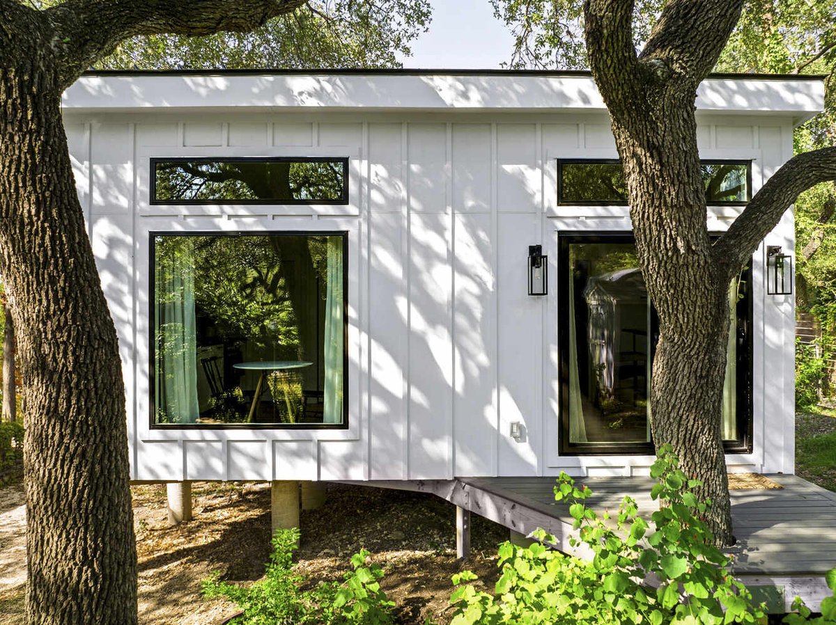 RedOven Builds modern custom home exterior with deck and wooded landscape Austin TX 3102 S Oak Dr