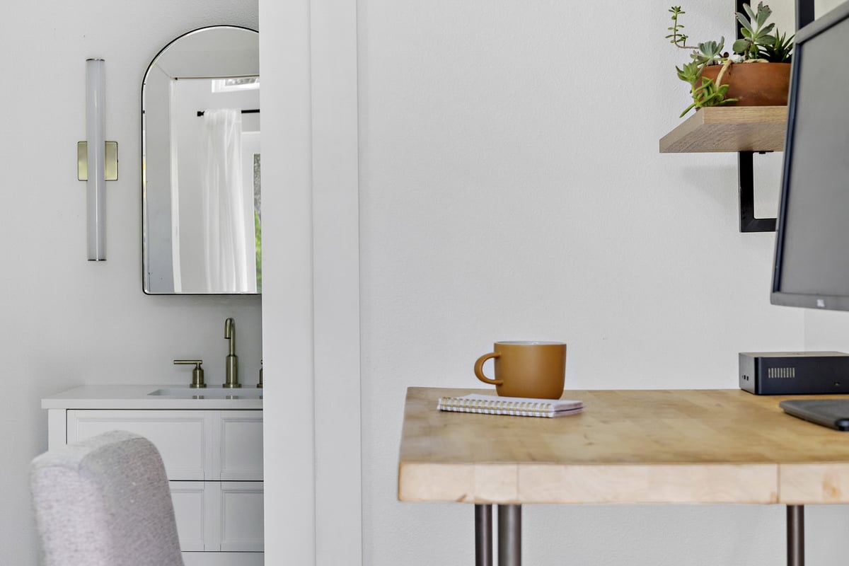 RedOven Builds modern custom home interior with desk and bathroom view Austin TX 3102 S Oak Dr