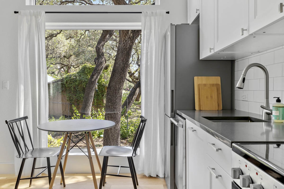 RedOven Builds modern custom home kitchen with dining nook and natural light Austin TX 3102 S Oak Dr