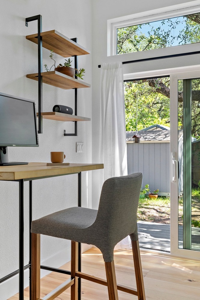 modern ADU office corner by RedOven Builds in 3102 S Oak Dr TX featuring minimalist desk and garden view