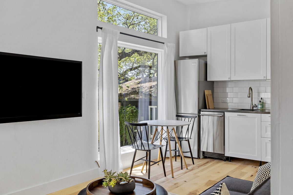 open ADU living and kitchen space by RedOven Builds in 3102 S Oak Dr TX with dining nook and large windows