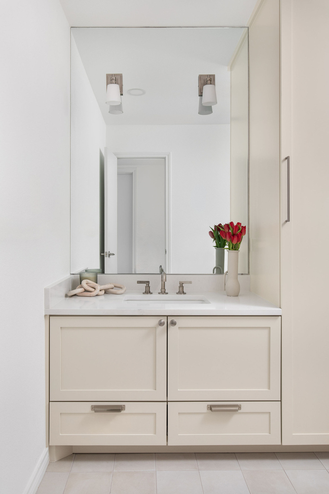 bathroom vanity remodel by RedOven Builds in Whitemarsh Austin TX with mirror and white cabinetry