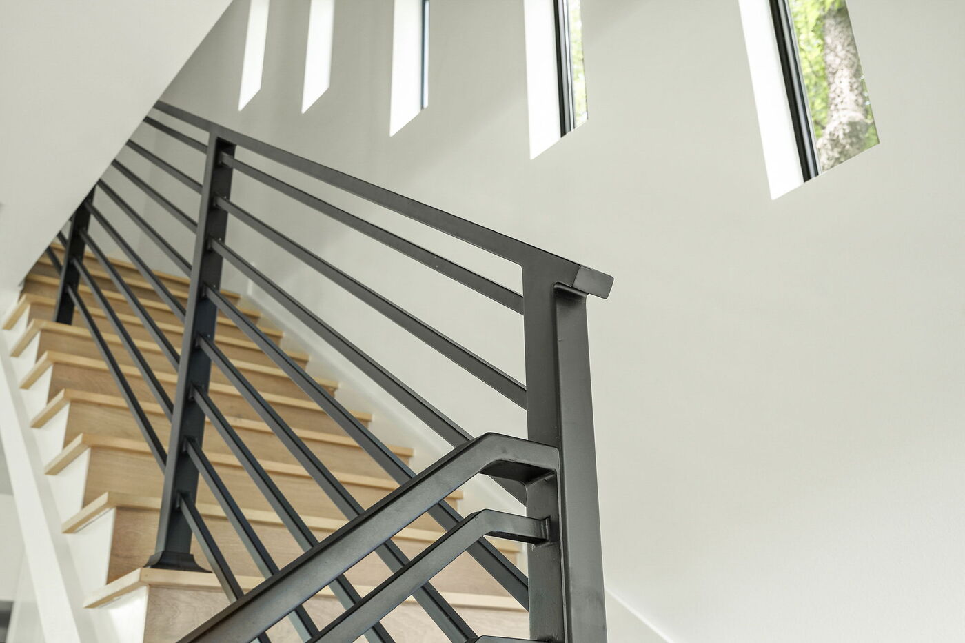 Close-up of staircase railing and wood steps in Brentwood, TX ADU by RedOven Builds