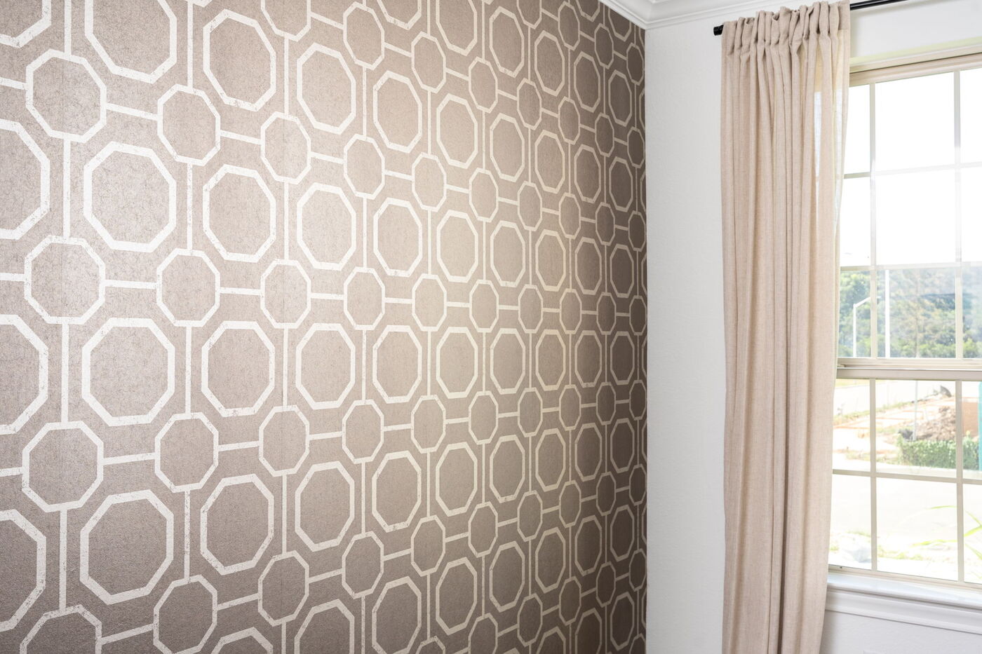 Close view of geometric wallpaper and window in Austin, TX remodel by RedOven Builds