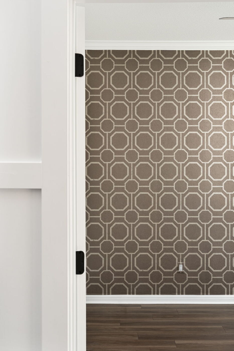 Geometric wallpaper accent wall seen through doorway in Austin, TX remodel by RedOven Builds