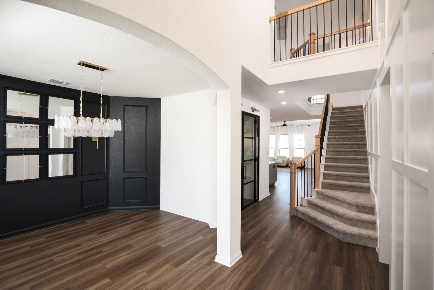 Open living and dining area with staircase in Austin, TX remodel by RedOven Builds