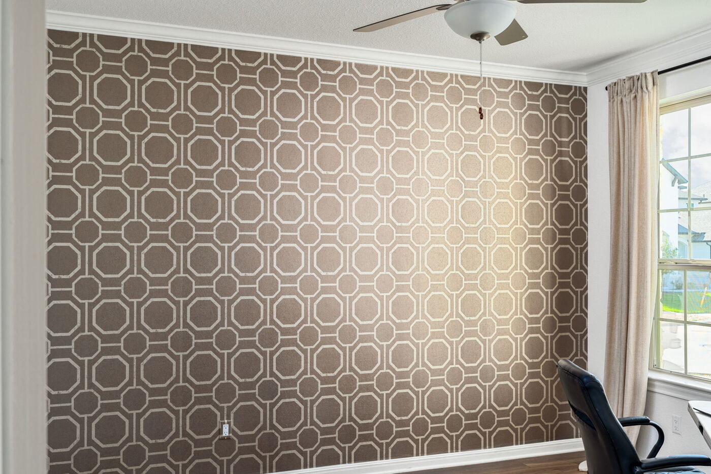 Room with full geometric accent wall and window in Austin, TX remodel by RedOven Builds