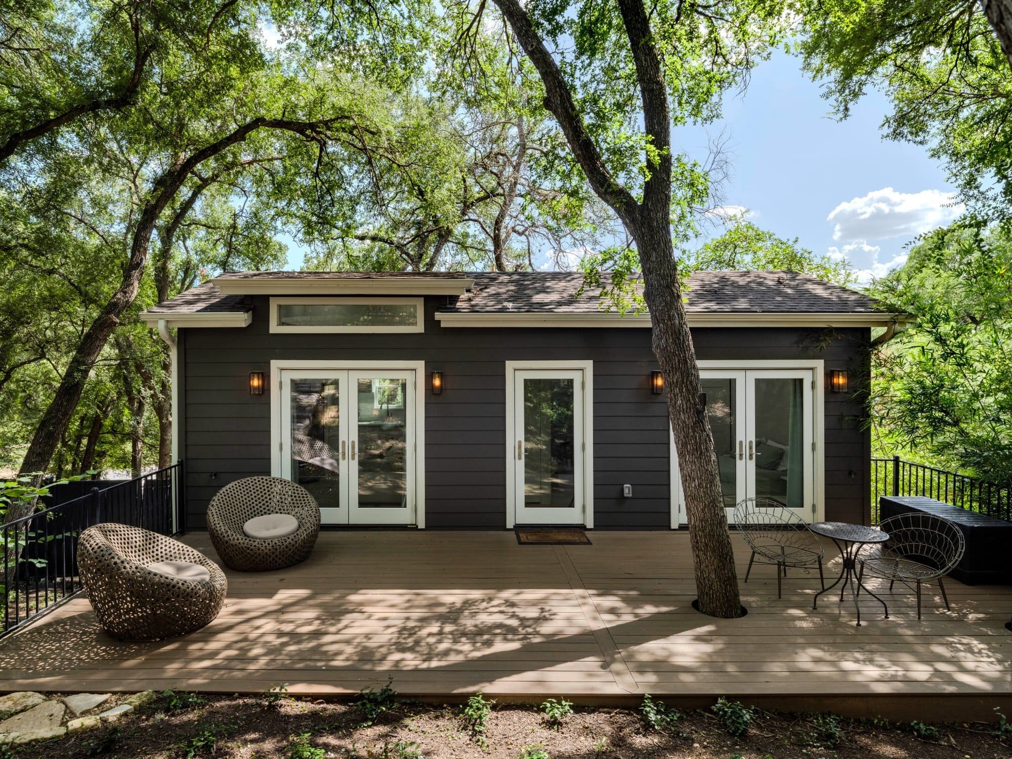 modern-exterior-with-wood-deck-and-natural-landscape-in-austin-texas-by-redoven-builds