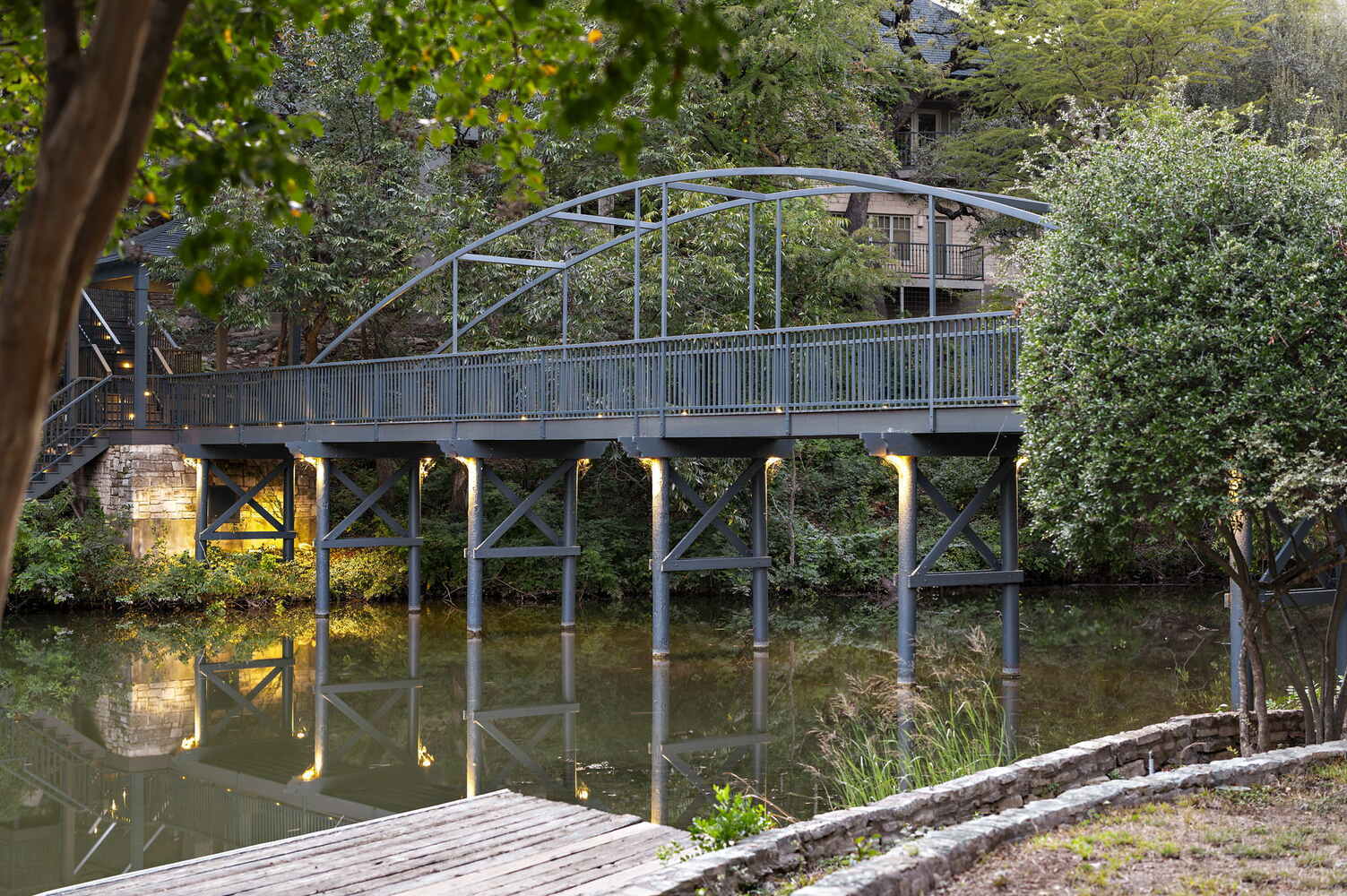 RedOven Builds commercial remodel bridge and dock area over water at 4408 Long Champ Dr Austin TX with landscaped shoreline