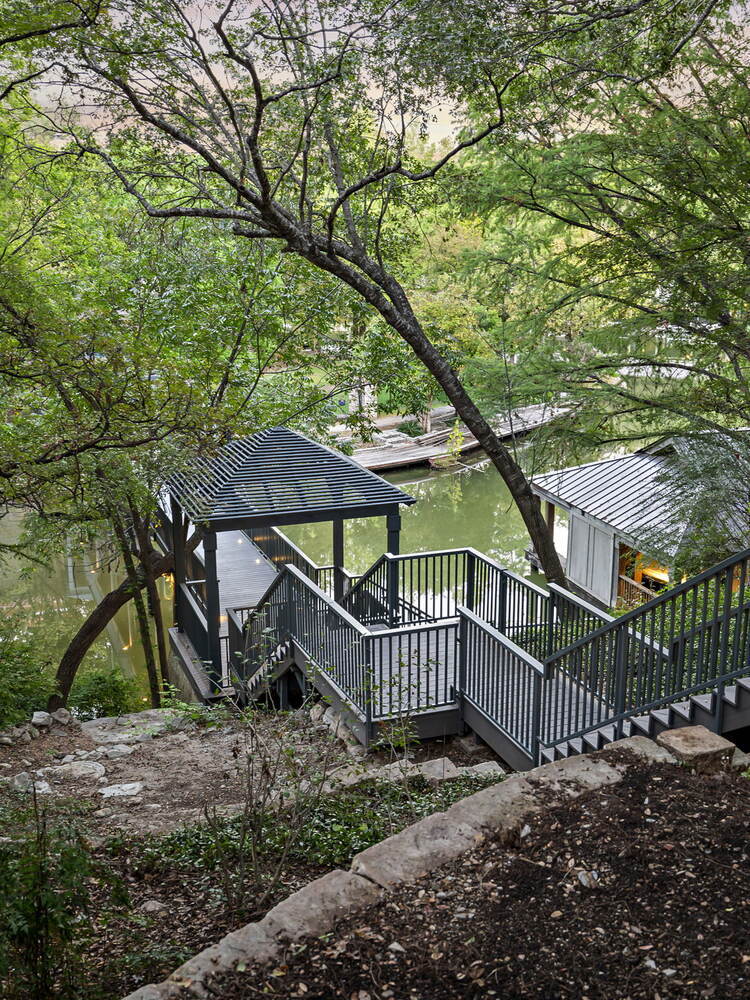 RedOven Builds commercial remodel hillside stairs and deck overlooking water at 4408 Long Champ Dr Austin, TX