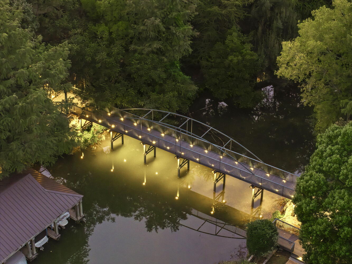 aerial close up of custom bridge lighting over water from RedOven Builds commercial remodel Austin TX