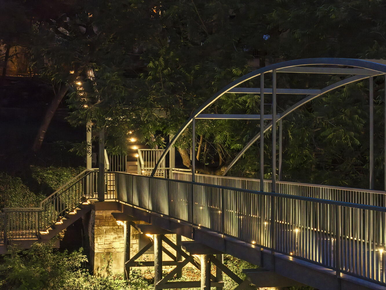 detailed evening view of bridge railing and support beams by RedOven Builds in Austin TX