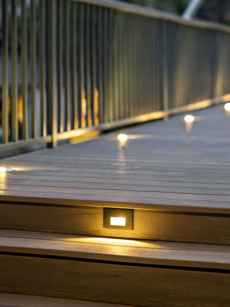 detailed view of illuminated stair riser lighting on deck by RedOven Builds in Austin TX