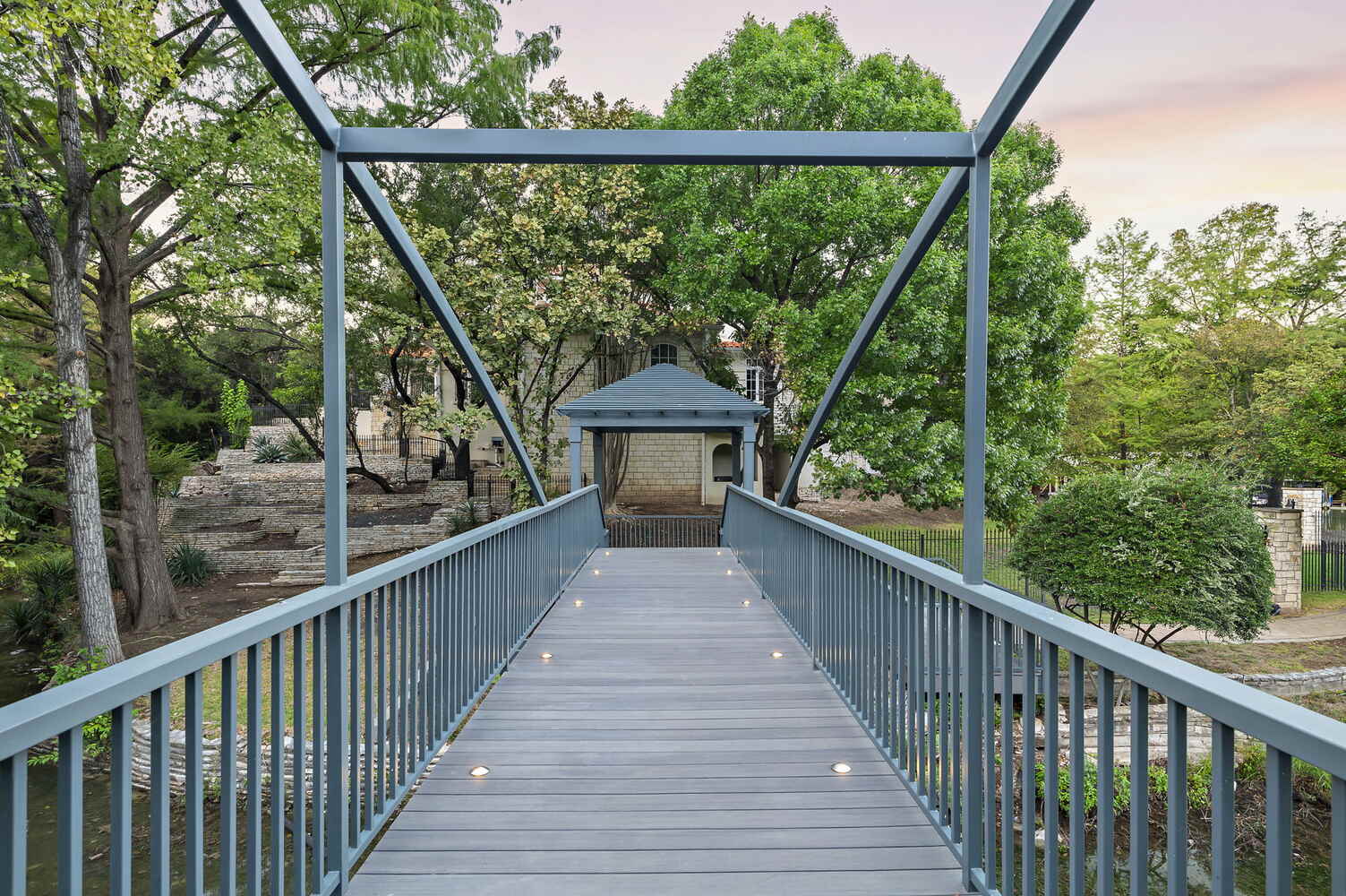 straight view across custom pedestrian bridge with railings by RedOven Builds in Austin, TX