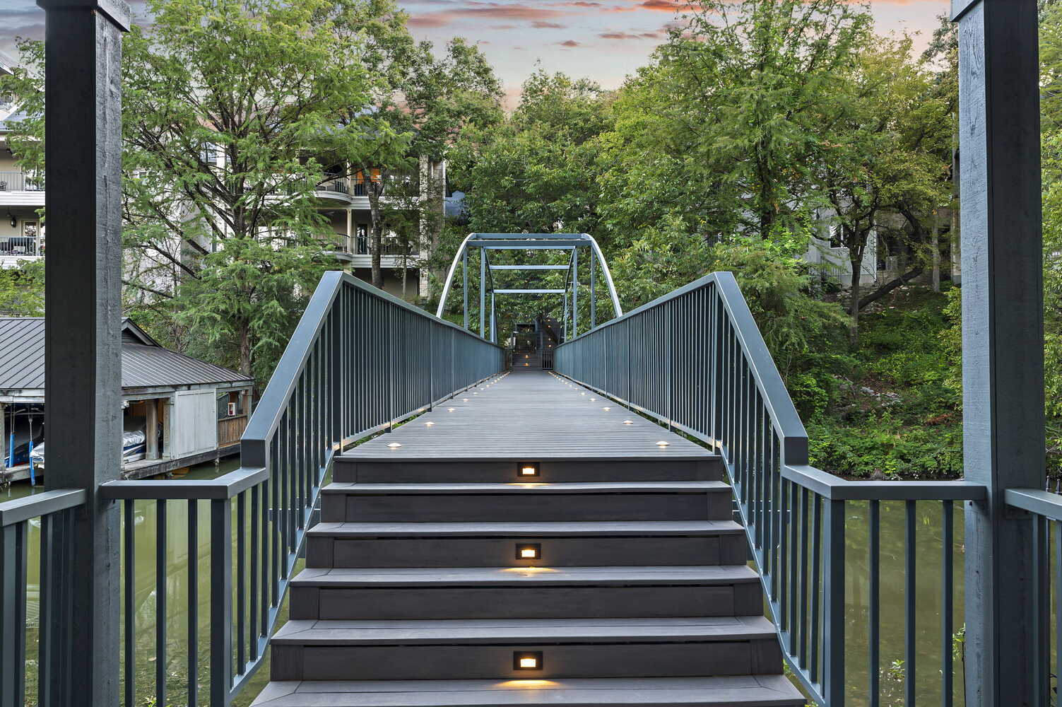 symmetrical stairway leading onto modern pedestrian bridge by RedOven Builds in Austin, TX