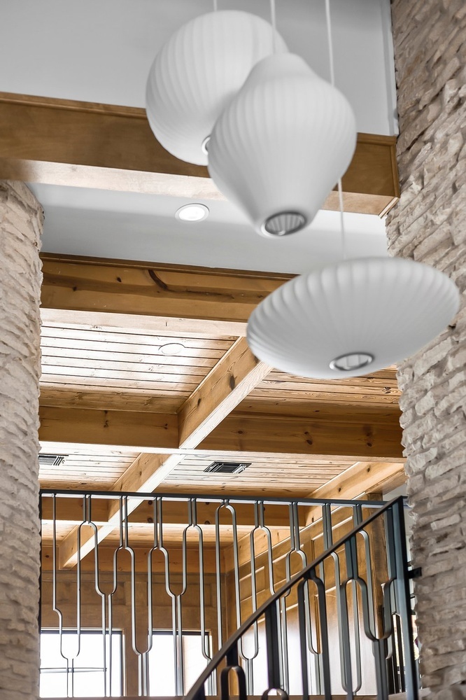 Austin TX home remodel showcasing custom metal railing and wood beams by RedOven Builds