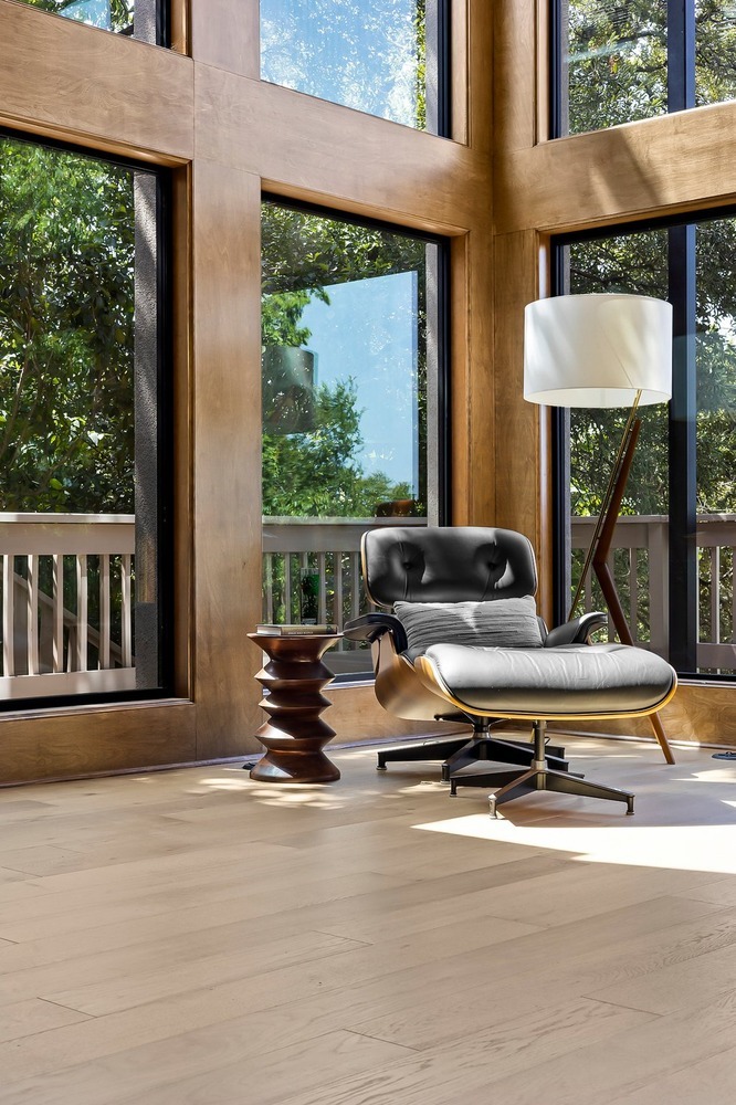 Austin TX remodel by RedOven Builds showcasing a modern seating area with large windows and natural wood trim