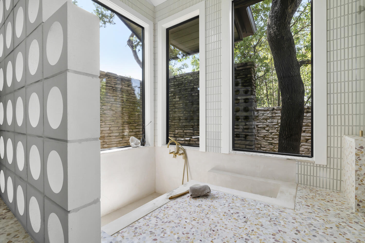 Bathroom tub with large windows and terrazzo flooring in a RedOven Builds Austin TX remodel