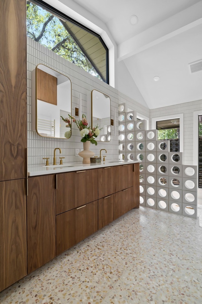 Bathroom vanity with modern mirrors and wood cabinetry in a RedOven Builds Austin TX remodel