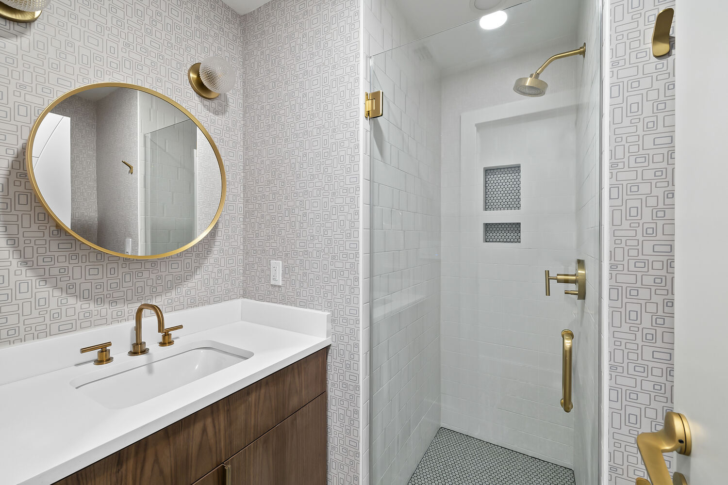 Compact bathroom design with walk-in shower and wood vanity in Austin TX remodel by RedOven Builds