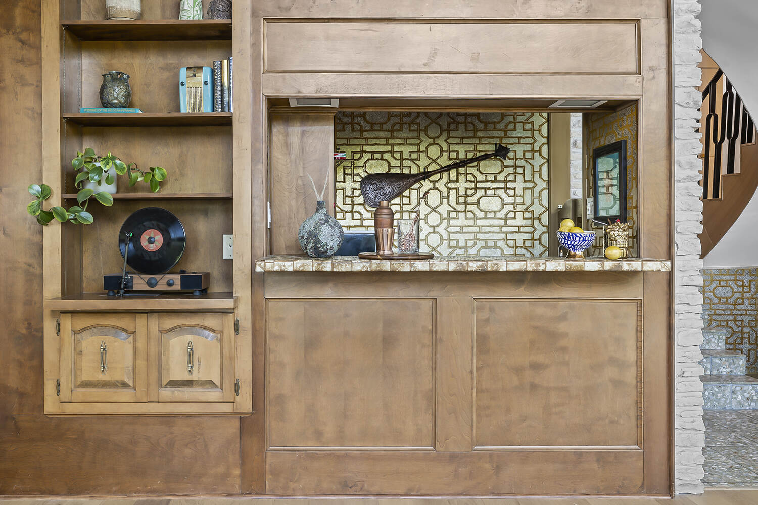 Custom bar and shelving detail in Austin TX remodel by RedOven Builds with warm wood tones and unique accents
