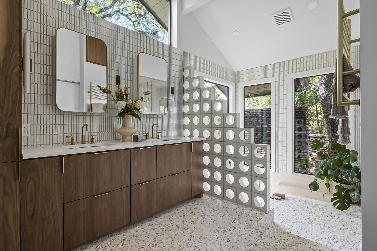 Elegant bathroom vanity with gold fixtures and modern tile in a RedOven Builds remodel in Austin, TX
