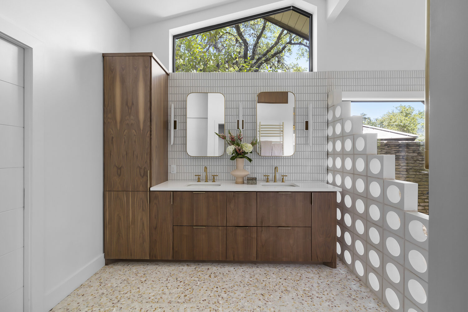 Modern bathroom design with wood cabinets, terrazzo floors, and natural light in Austin TX by RedOven Builds
