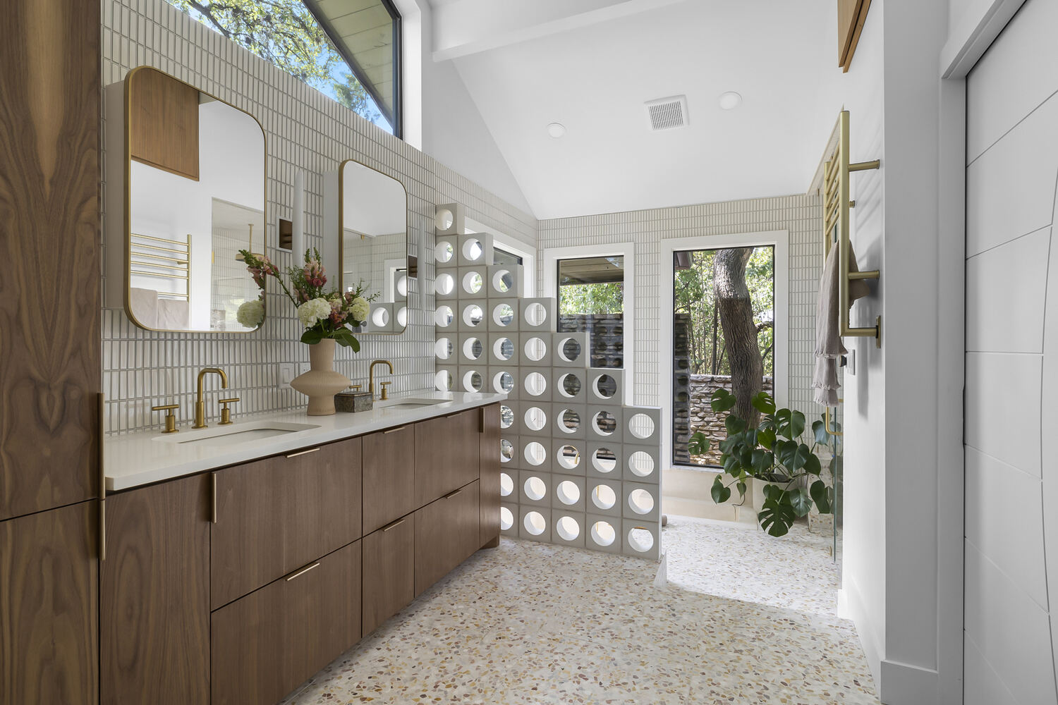Modern bathroom with double vanity and decorative block wall in a RedOven Builds remodel in Austin, TX