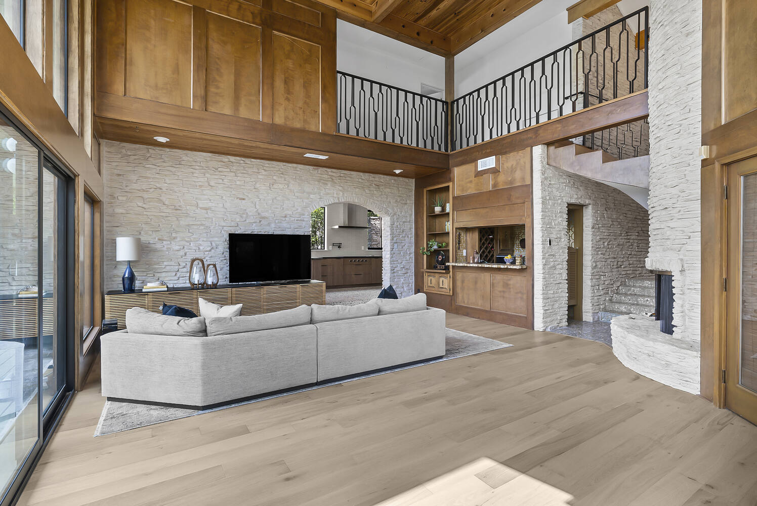 Open concept living room in Austin TX by RedOven Builds with stone fireplace and modern architectural details