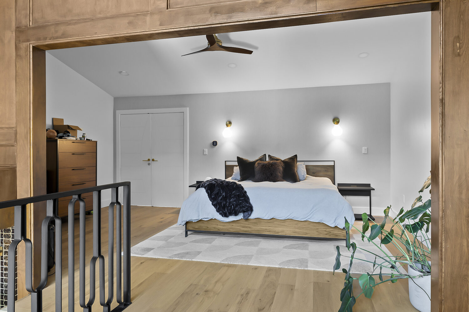 RedOven Builds Austin TX bedroom remodel with modern bed, wood floors, and minimalist design