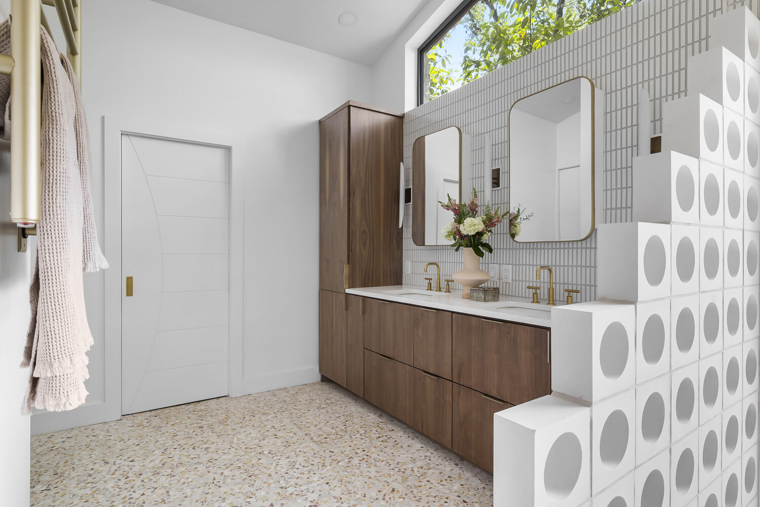 Spacious bathroom with dual sinks, terrazzo floors, and custom cabinetry in Austin TX by RedOven Builds