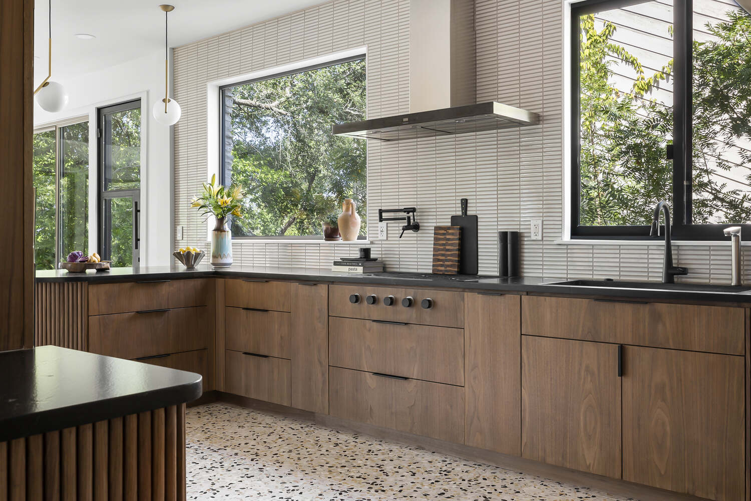angled kitchen view with large windows and custom cabinetry by RedOven Builds in Austin TX