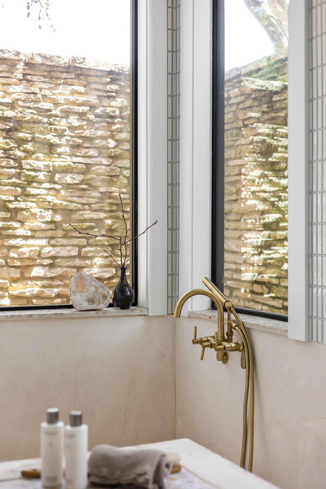 custom bathroom shower with brass fixtures and window detail by RedOven Builds in Austin Texas