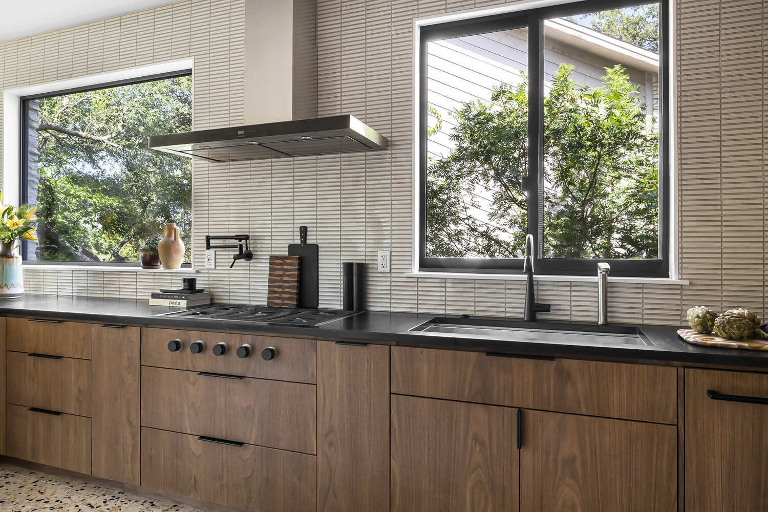 kitchen sink area with modern fixtures and window view in Austin TX full home remodel by RedOven Builds