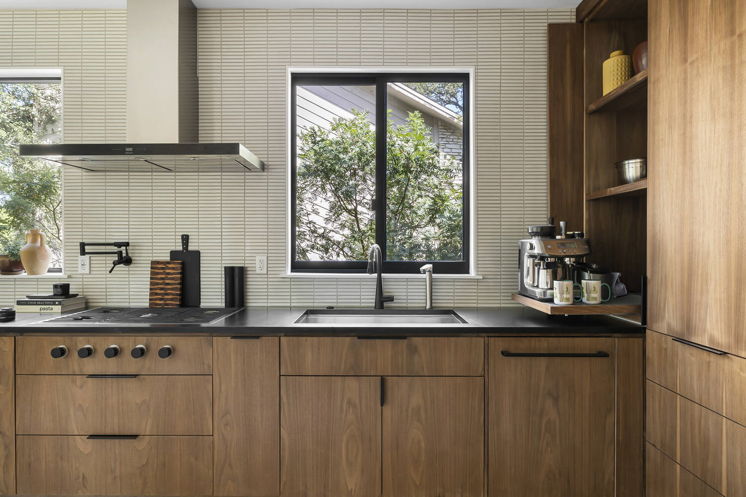 kitchen sink wall with large windows and modern cabinetry by RedOven Builds Austin TX