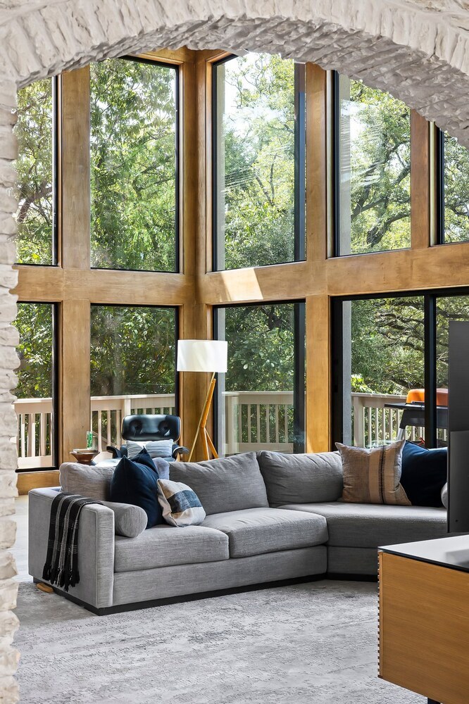 living room with large windows and modern sectional sofa in Austin TX remodel by RedOven Builds