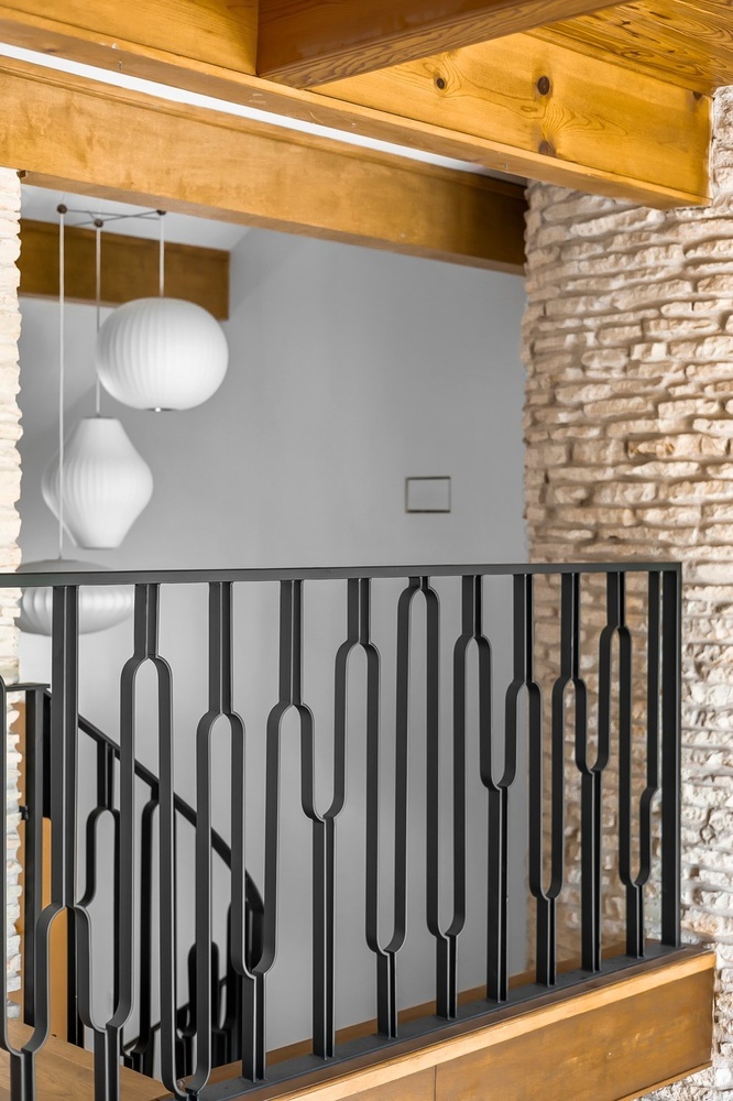 modern interior railing design with geometric metal pattern by RedOven Builds in Austin TX