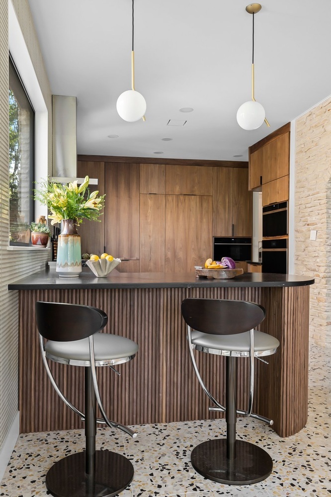 modern kitchen island with bar stools and pendant lighting by RedOven Builds Austin TX remodel