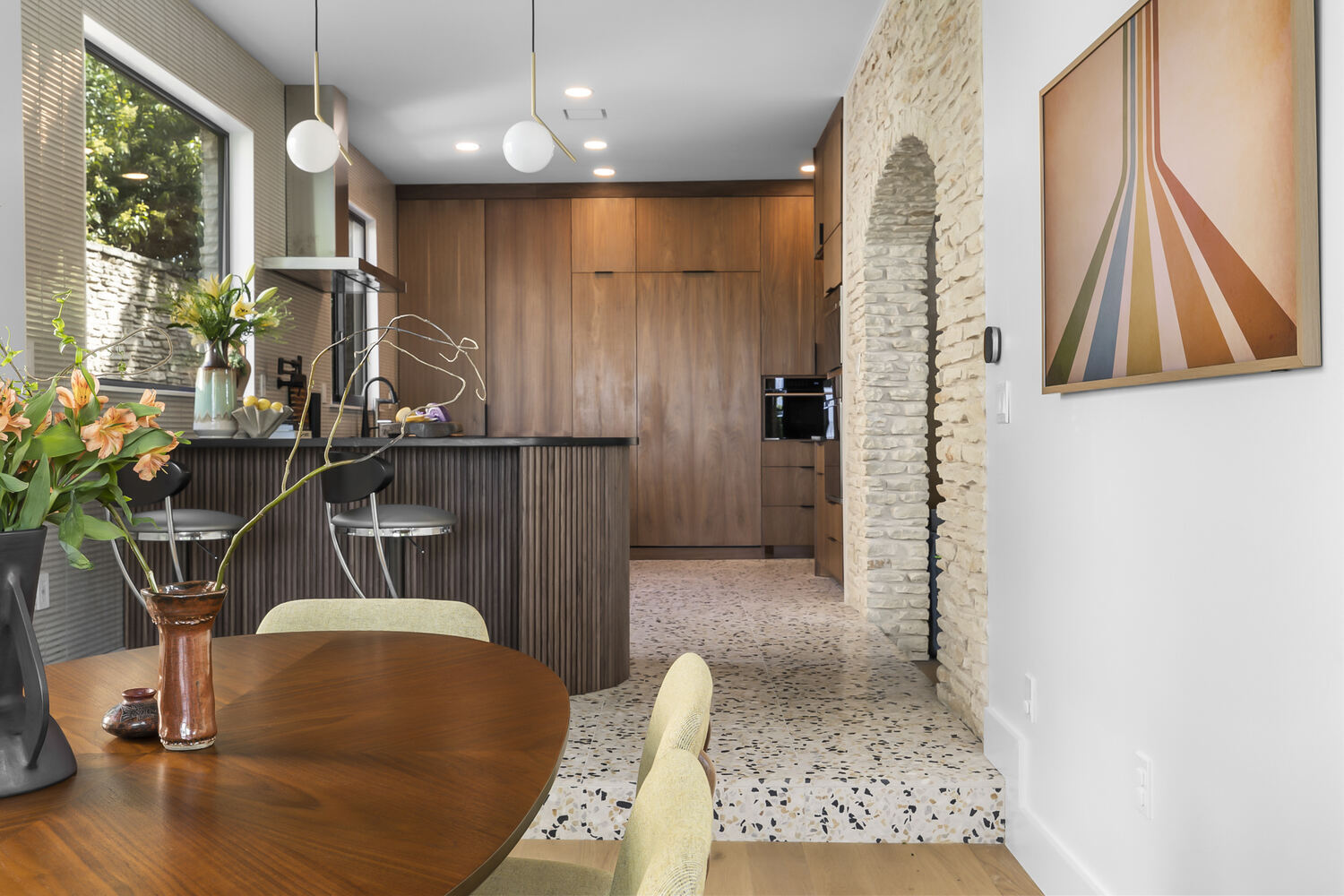 modern kitchen with wood cabinetry and island seating in Austin TX full home remodel by RedOven Builds