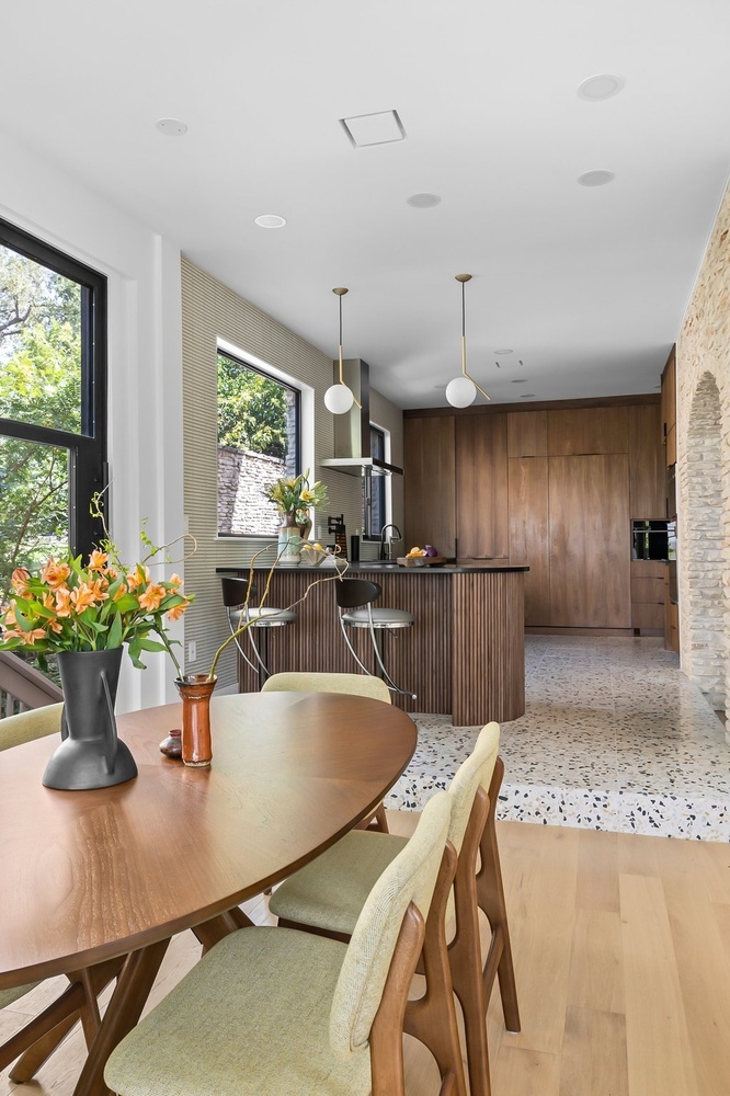 open concept dining and kitchen area with wood cabinetry by RedOven Builds Austin TX
