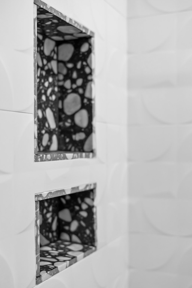 shower niche with terrazzo tile detail by RedOven Builds Austin TX bathroom remodel